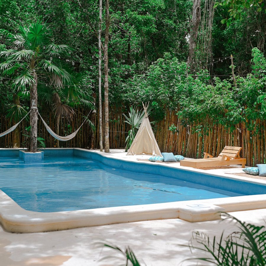 The cenote-fed pool and hammocks at Lunita