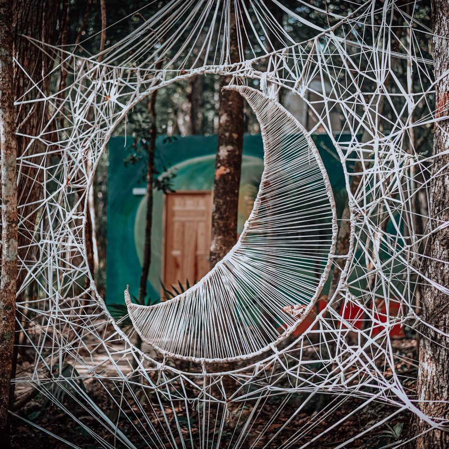 Moon string art in a jungle ceremony space