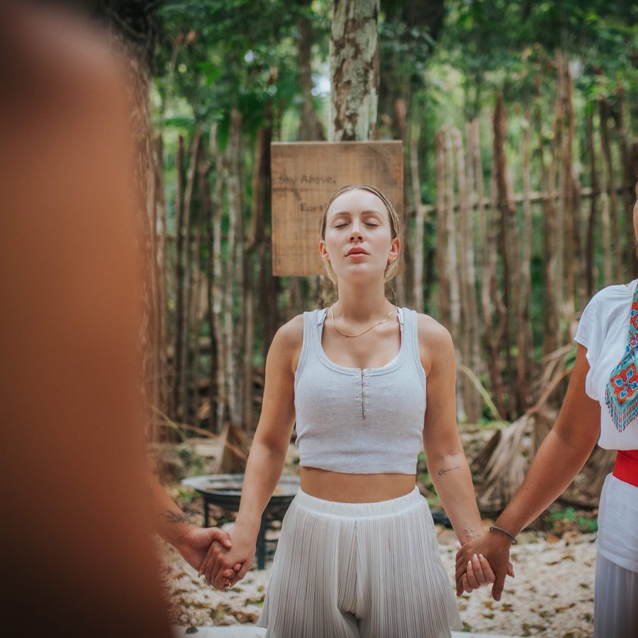 Hands joined in a retreat circle ceremony