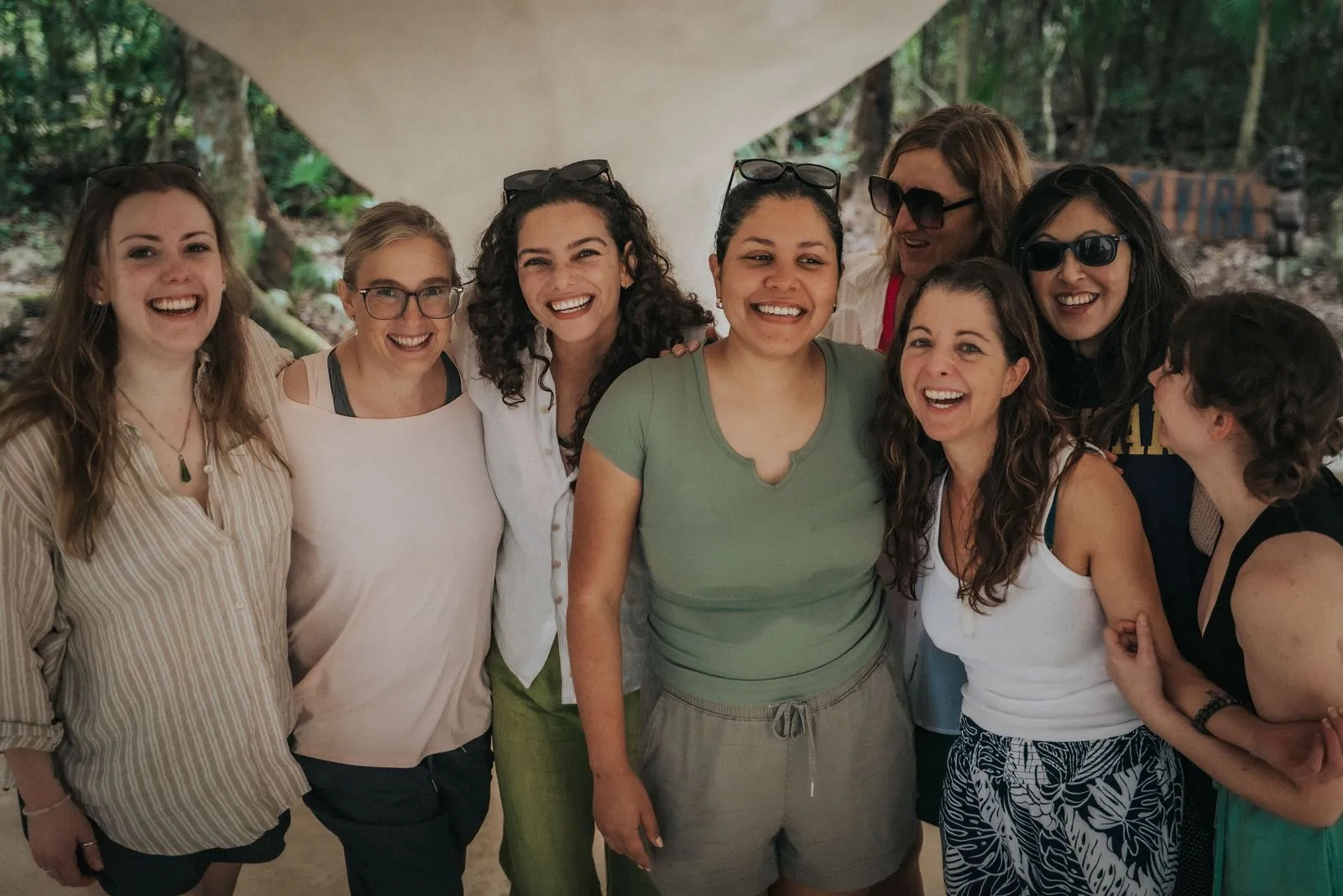 A facilitator with a group mid-retreat, or a warm welcome scene, wide horizontal. Trust and partnership