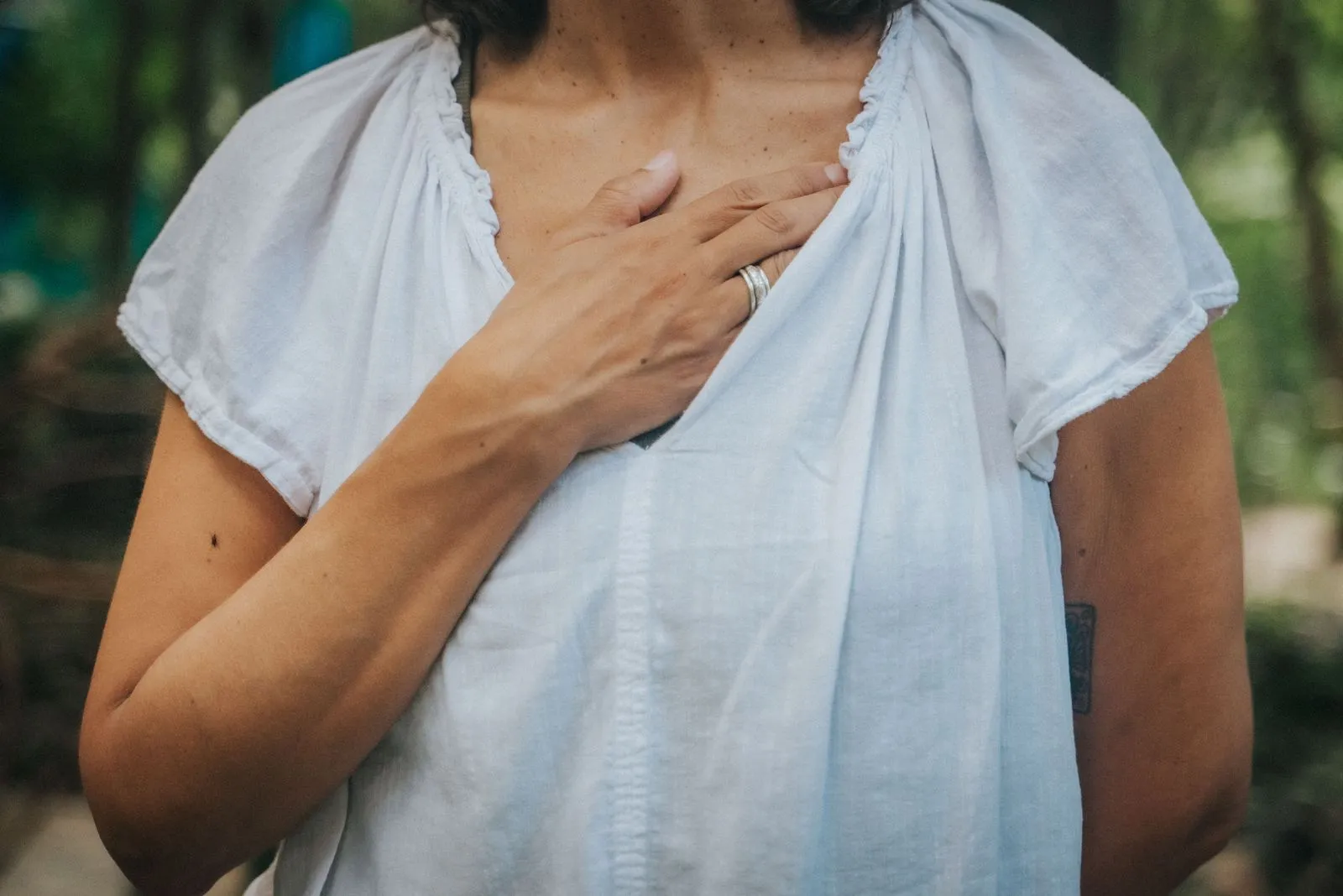 A woman in a pale blue linen shirt, face cropped out of frame, Lunita Jungle Retreat