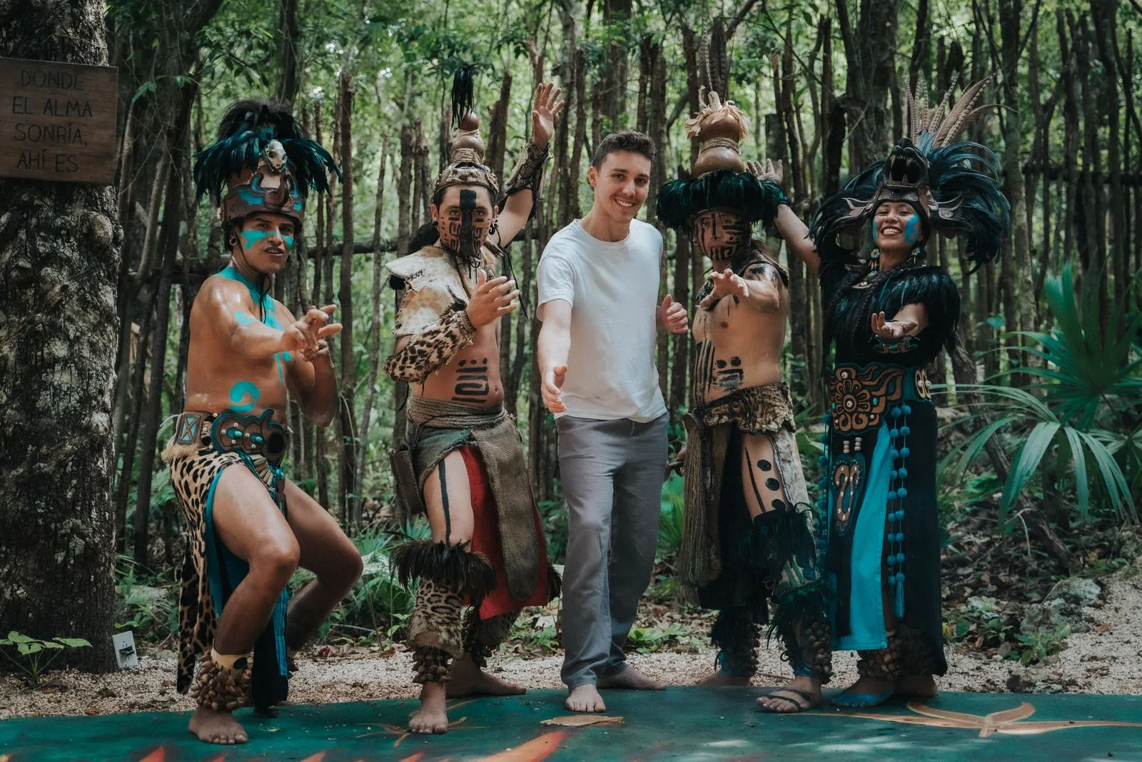 A guest in a white shirt stands centered on a teal platform in dense jungle, Lunita Jungle Retreat
